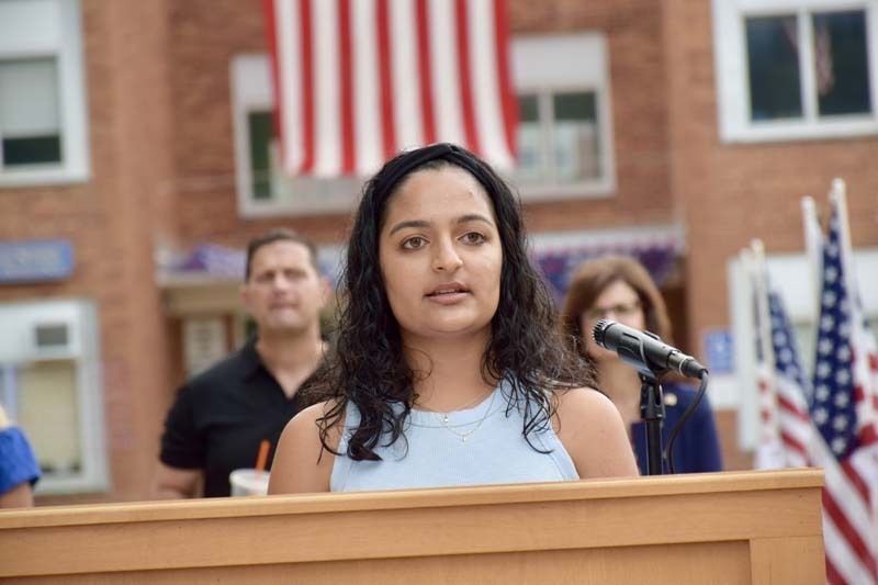 Woman giving speech at podium.