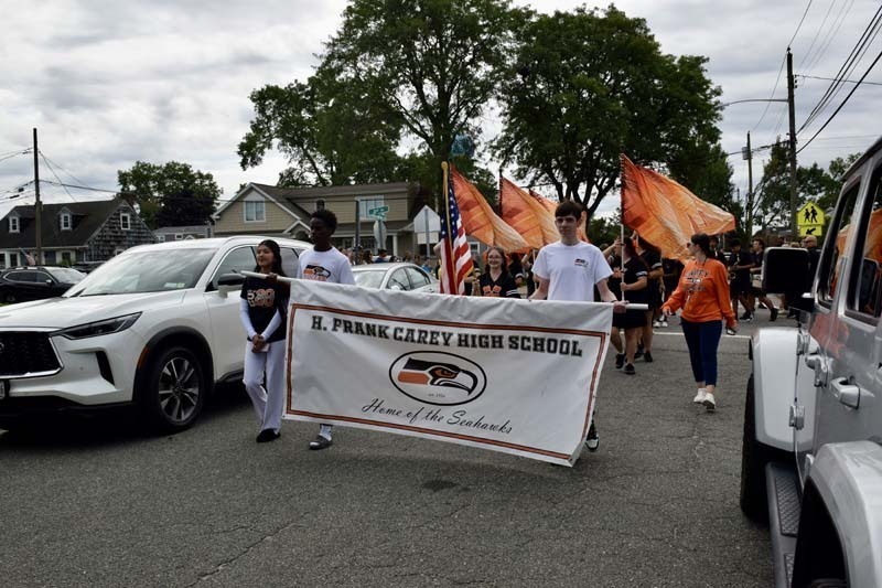 Students and family members marching in parade.