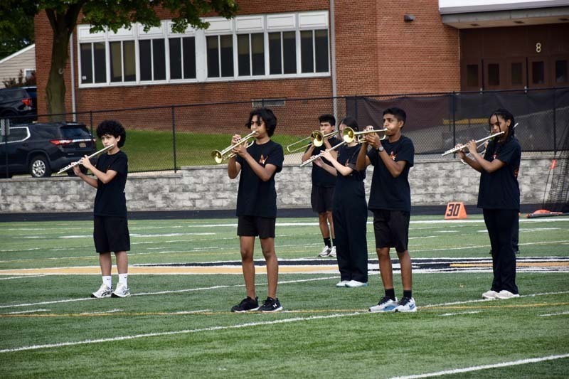 Student band performing on field.