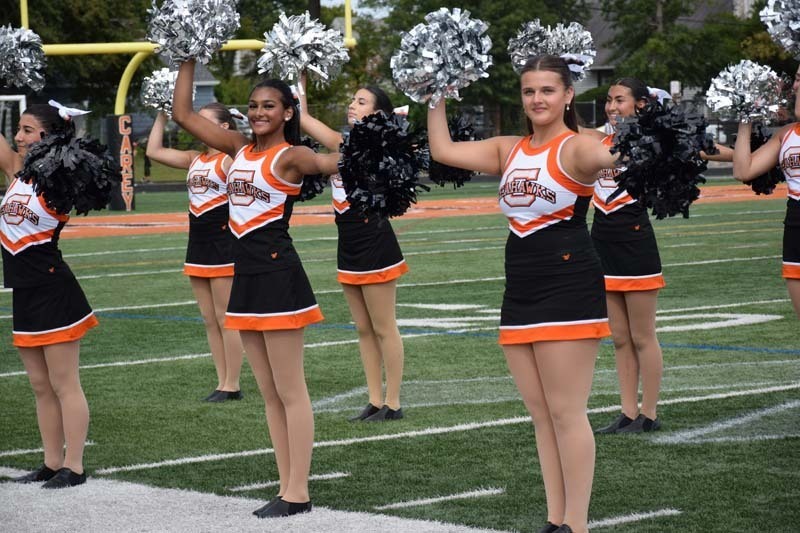 Cheerleaders performing on field.