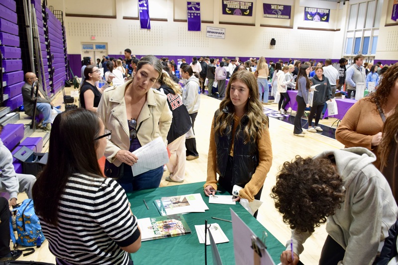 Students talking to representatives at career fair.