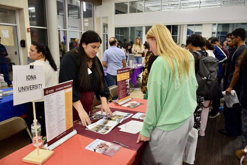 Students talking to representatives at career fair.