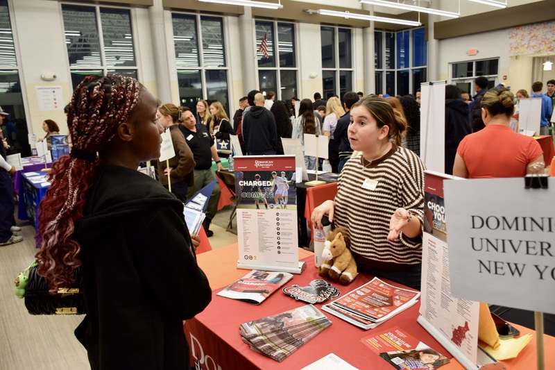 Students talking to representatives at career fair.
