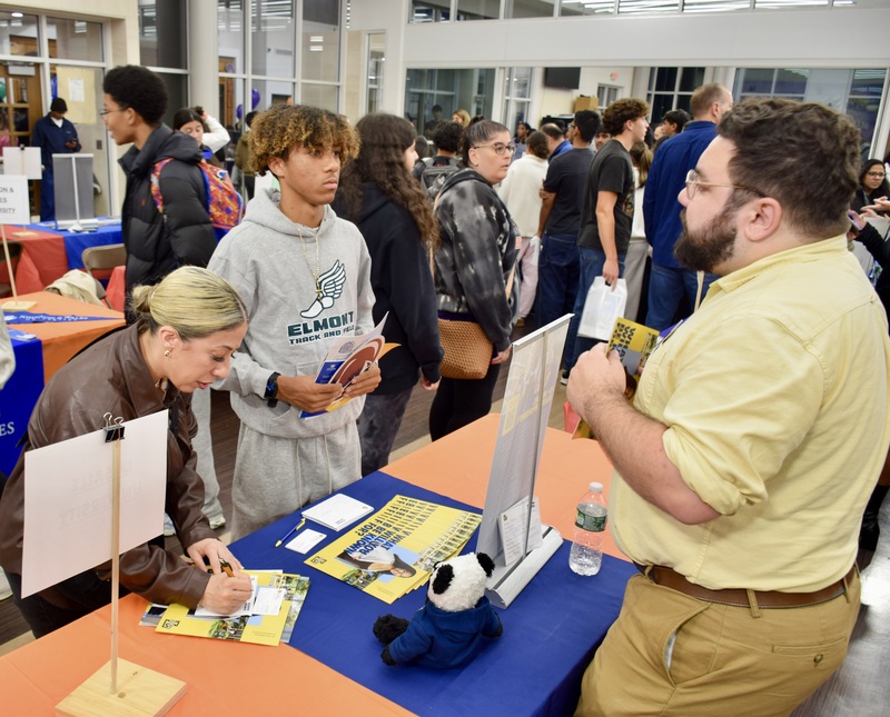 Students talking to representatives at career fair.