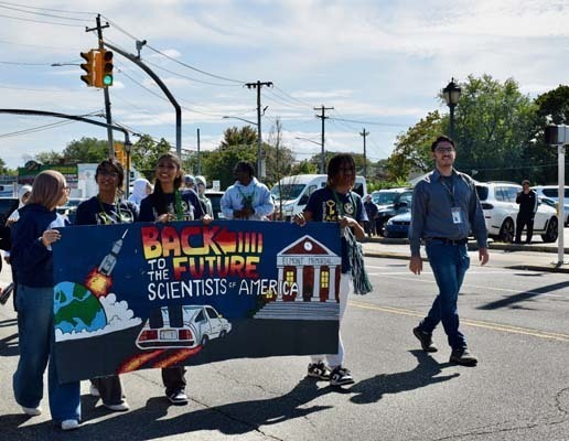 Homecoming Parade, students holding a banner
