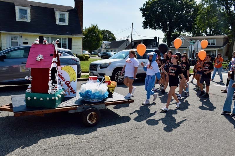 Students walk in the homecoming parade