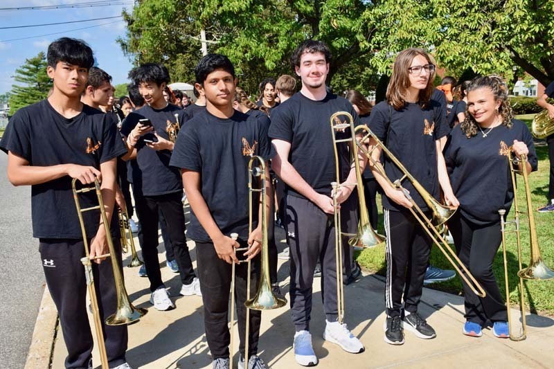 Members of the marching band await the homecoming parade.