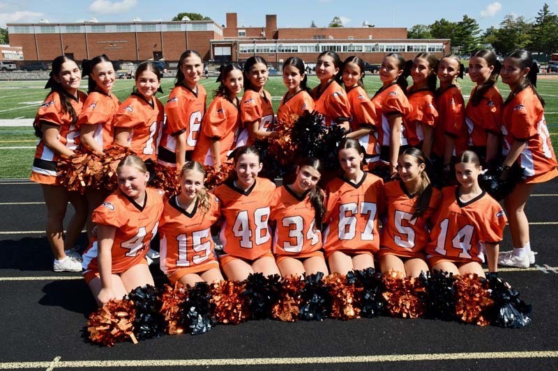 Junior varsity cheerleaders pose for a photo before the homecoming game