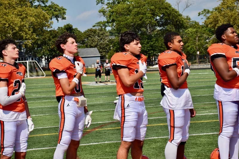 Football players during the Pledge of Allegiance