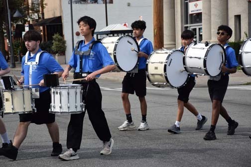 The band walks in the homecoming parade.