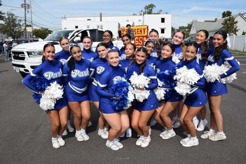 Varsity cheerleaders pose for a photo before the parade.