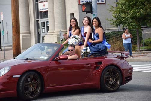 Homecoming court members are driven in the parade.