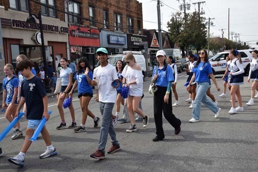 Students walk in the homecoming parade.