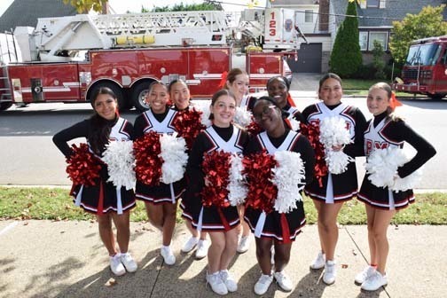Cheerleaders pose for a photo before the homecoming parade.
