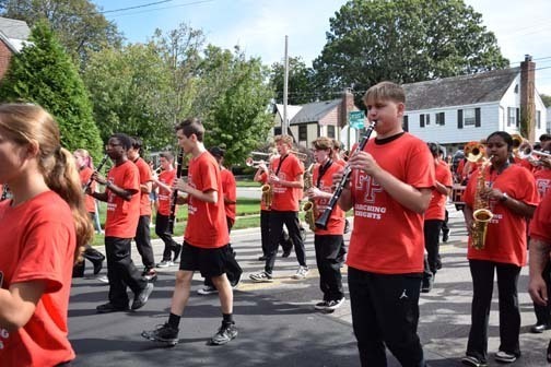 The color guard and marching band await the parade.
