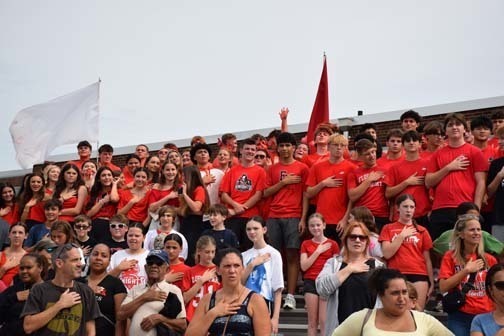 Students smile from a car in the homecoming parade.