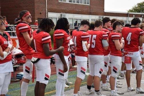 Students wave and smile in the homecoming parade.