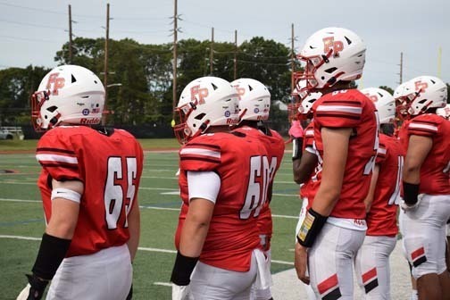 The Knights are pictured during the Pledge of Allegiance.