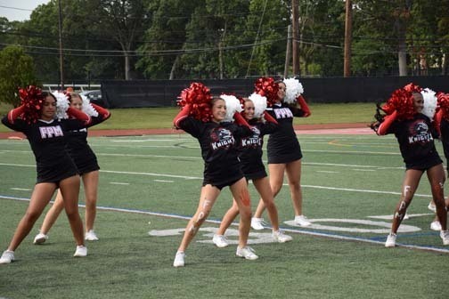 The varsity cheerleaders perform during halftime.