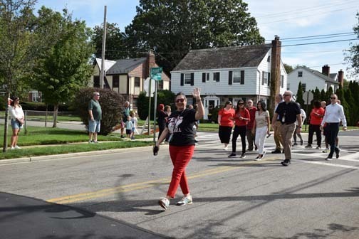Students wave and smile in the homecoming parade.