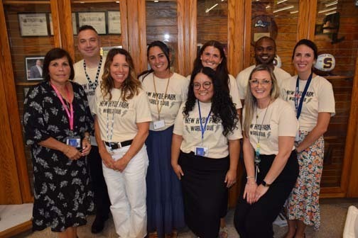 Students and teachers smiling together.