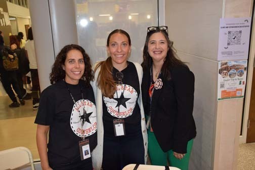 Students and teachers smiling together.