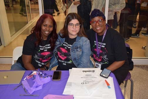 Students and teachers smiling together.