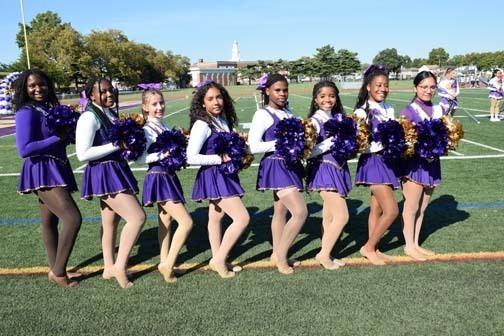 Cheerleaders perform before the homecoming game.