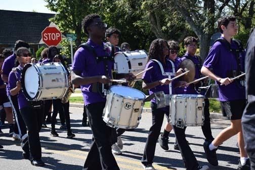 Marching band students perform and walk in the parade.