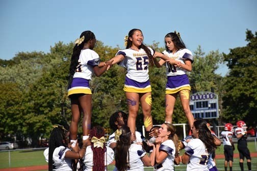 Cheerleaders perform before the homecoming game.