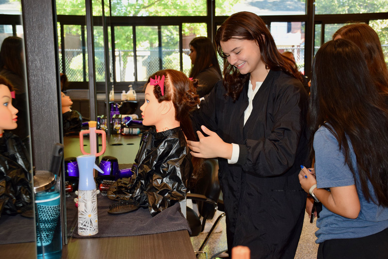 students styling hair