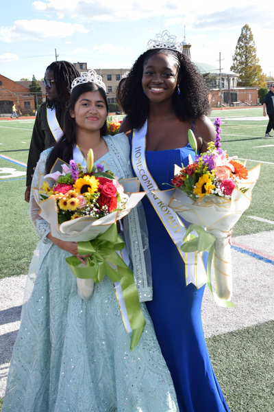 2 students holding bouquets