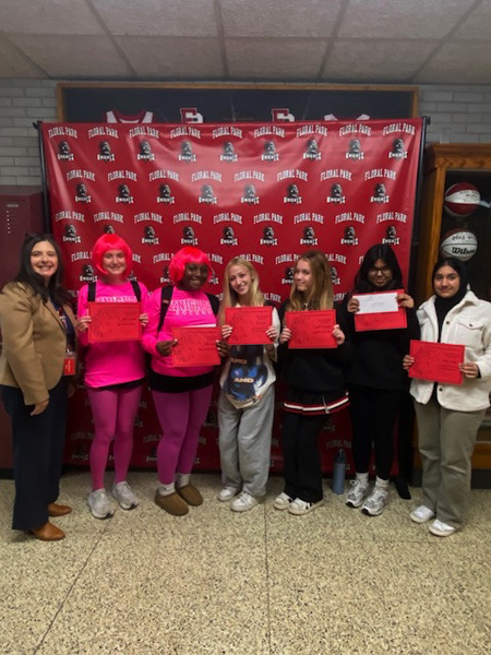 students in hallway with red papers