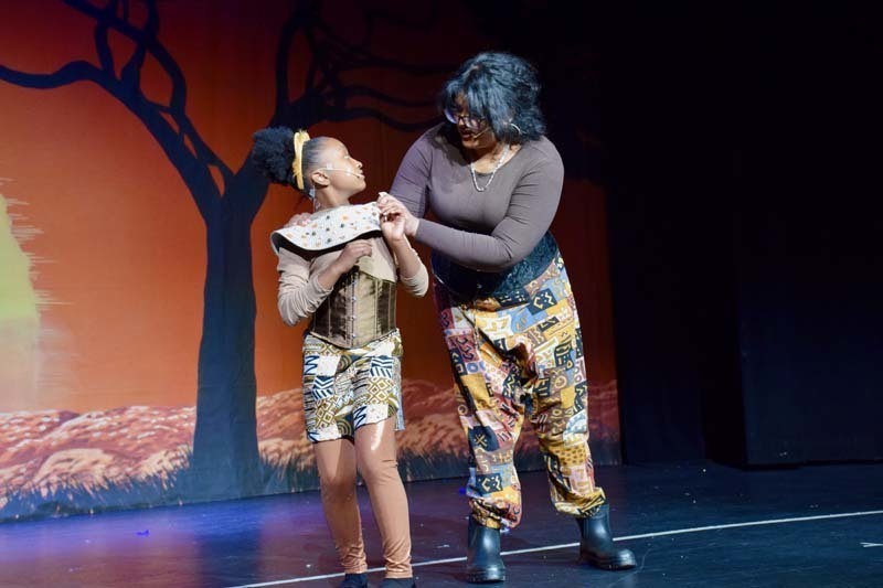 Students on stage preforming 'Lion King'