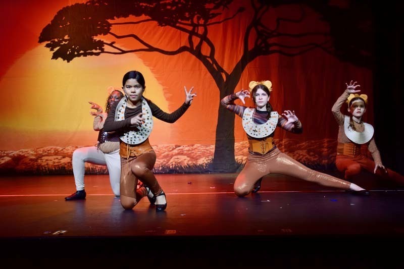 Students on stage preforming 'Lion King'