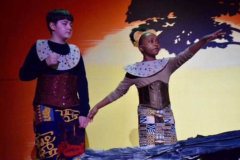 Students on stage preforming 'Lion King'