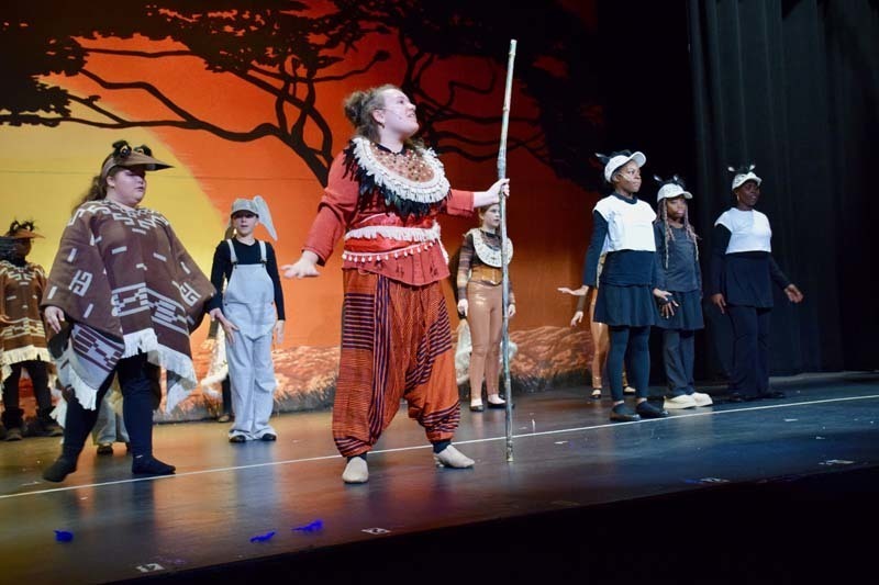 Students on stage preforming 'Lion King'