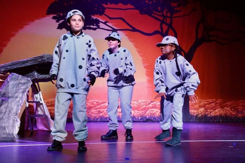 Students on stage preforming 'Lion King'