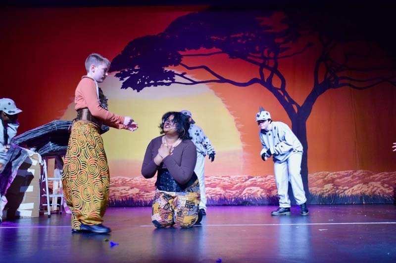 Students on stage preforming 'Lion King'