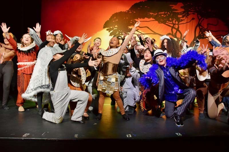 Students on stage preforming 'Lion King'