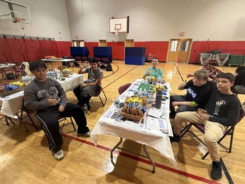 Students sitting together at table.