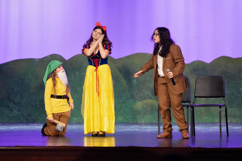 students perform in a play onstage