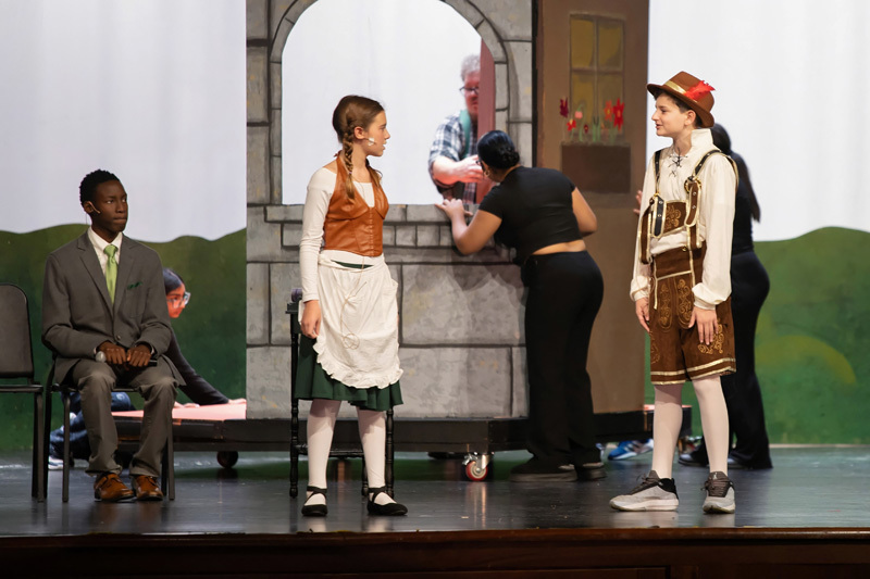 students perform in a play onstage