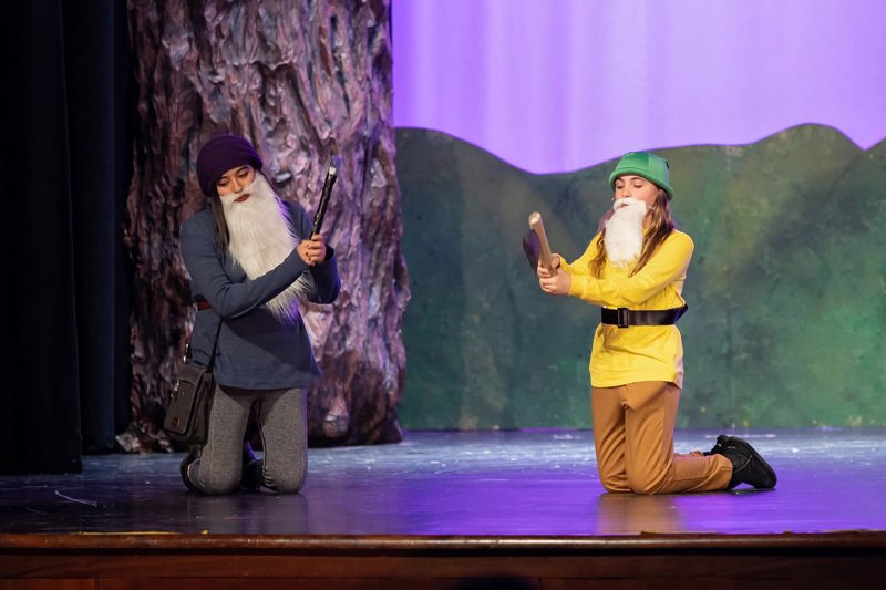 students perform in a play onstage