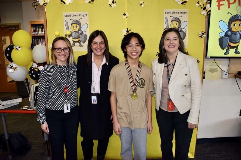 Students standing with teachers.