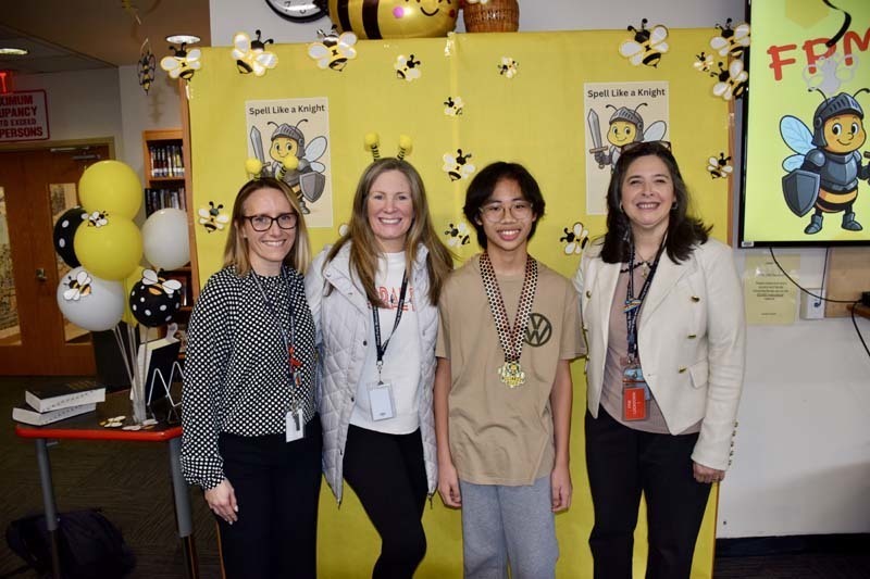 Students standing with teachers.