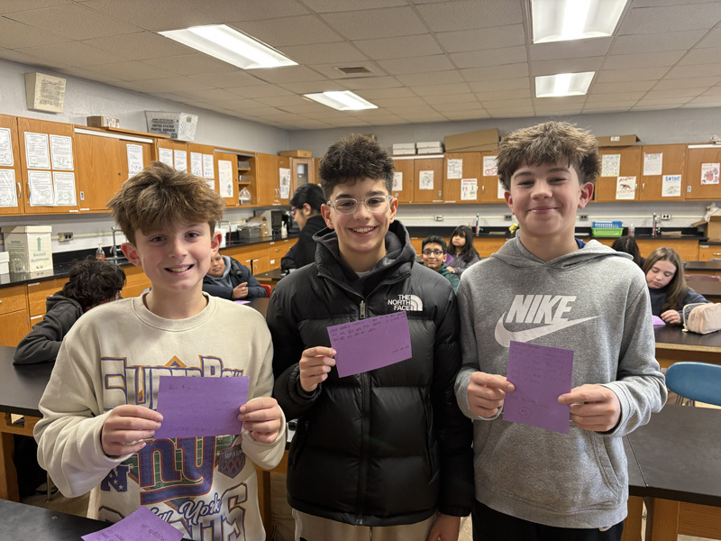 student with purple paper craft