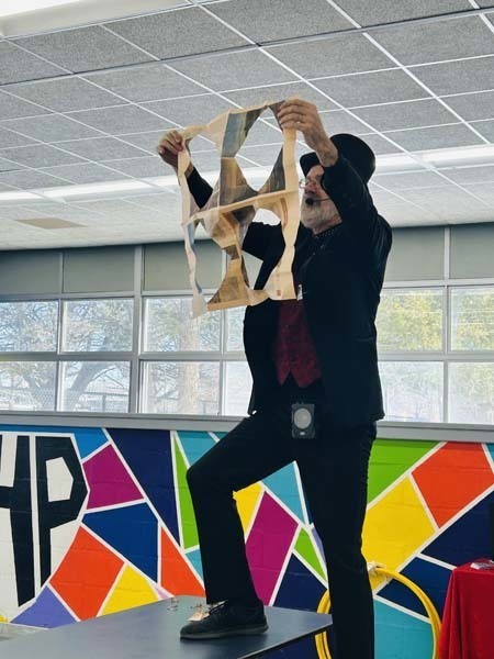 Magician performing for students.
