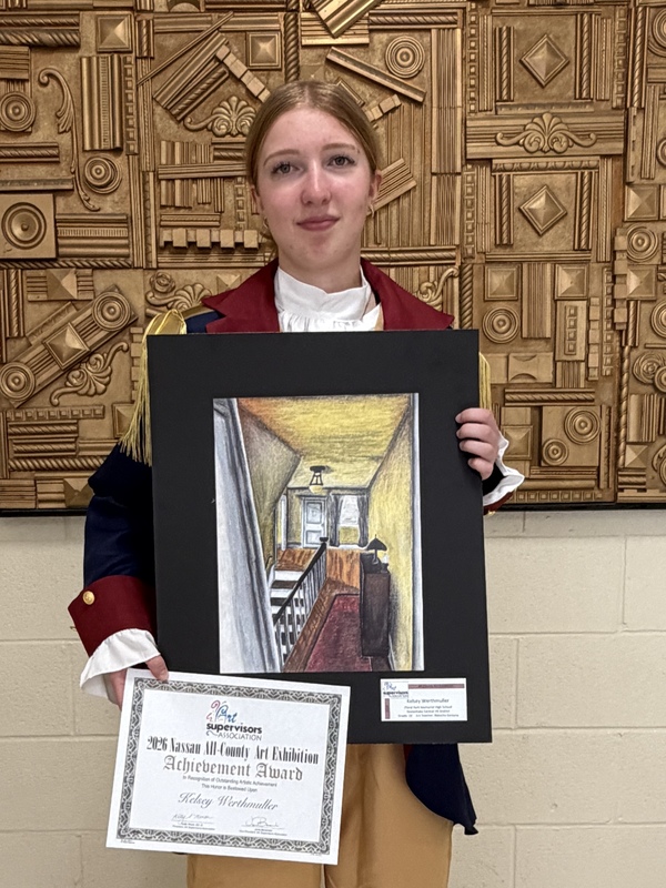 Student holding award.