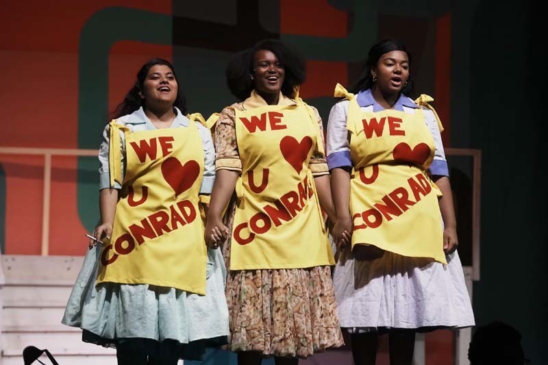 Students dressed in costume performing.